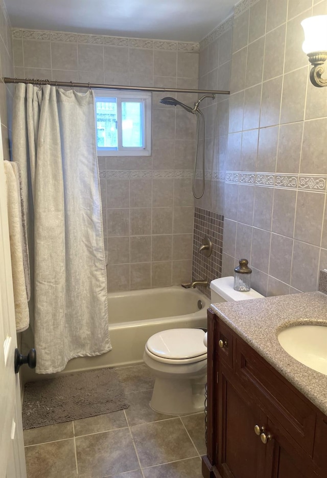 full bathroom featuring tile patterned floors, toilet, tile walls, vanity, and shower / bathtub combination with curtain