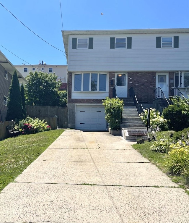 view of front of house featuring a garage and a front yard