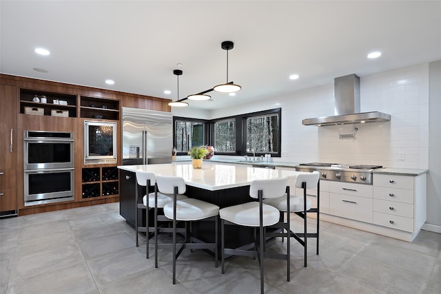 kitchen with modern cabinets, appliances with stainless steel finishes, island exhaust hood, light countertops, and open shelves