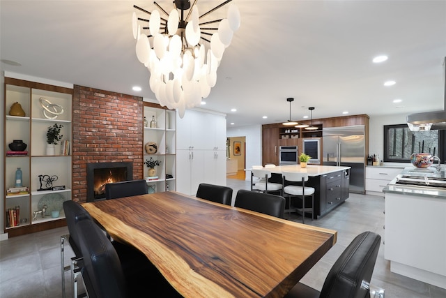 dining area featuring built in shelves, a fireplace, and recessed lighting