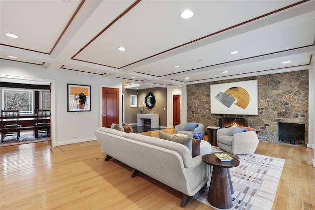 living area with a fireplace, light wood-style floors, coffered ceiling, beamed ceiling, and baseboards