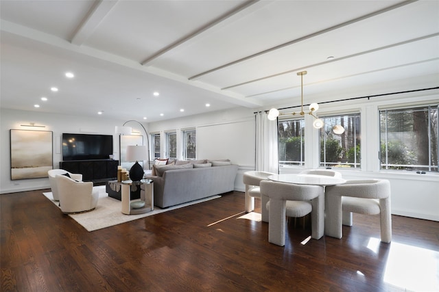 dining area featuring a chandelier, wood finished floors, beam ceiling, and recessed lighting