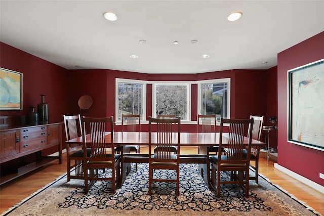 dining room featuring recessed lighting, baseboards, and wood finished floors