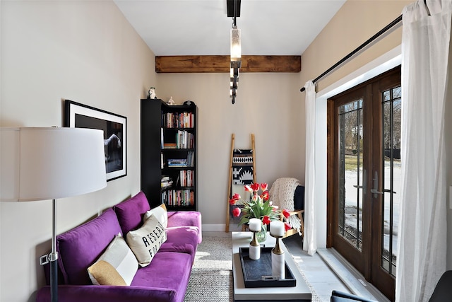 living room featuring french doors, beam ceiling, and baseboards