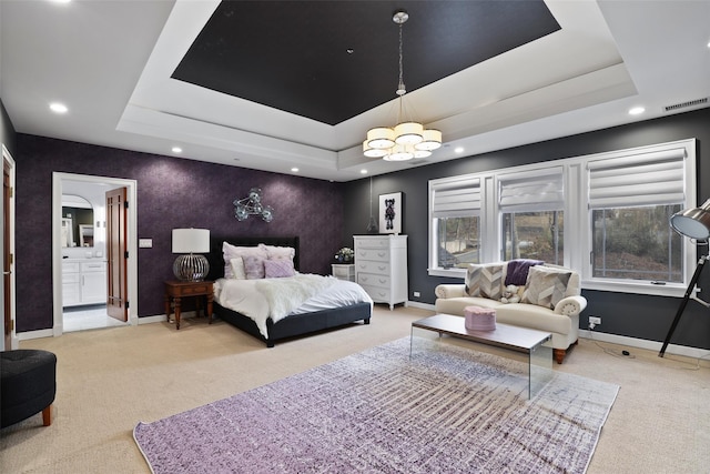 carpeted bedroom featuring a tray ceiling, visible vents, and baseboards