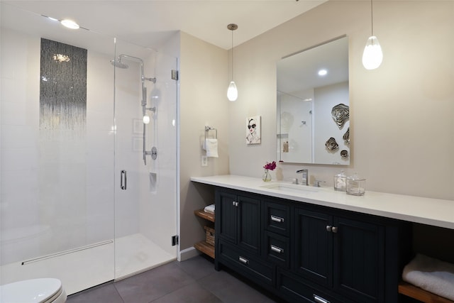 bathroom with vanity, a shower stall, toilet, and tile patterned floors