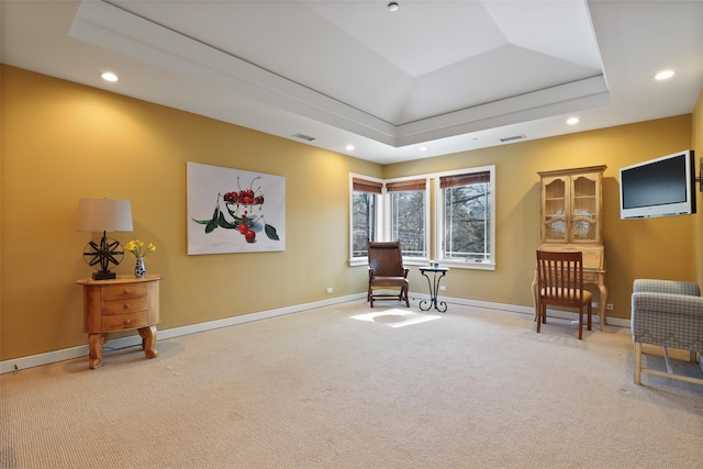 sitting room with baseboards, a tray ceiling, carpet flooring, and recessed lighting