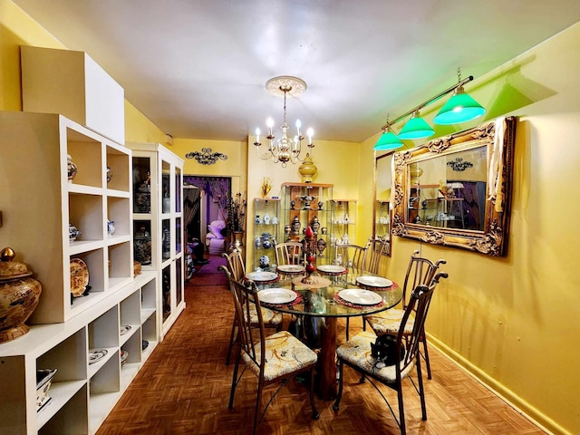 dining room featuring baseboards and a notable chandelier