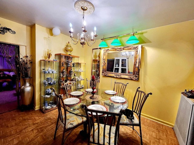 dining space with baseboards and an inviting chandelier