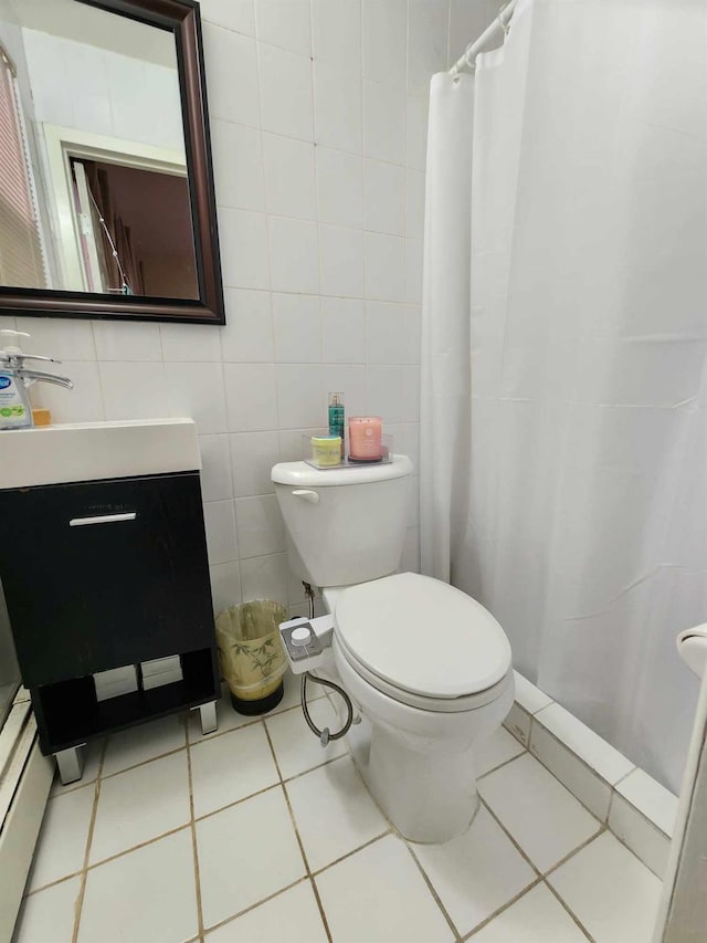 bathroom featuring vanity, a shower with curtain, tile patterned flooring, tile walls, and toilet