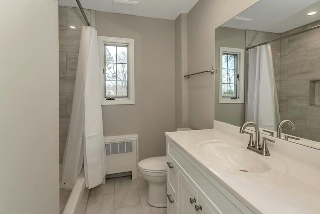 bathroom featuring toilet, radiator heating unit, shower / bath combo, and vanity