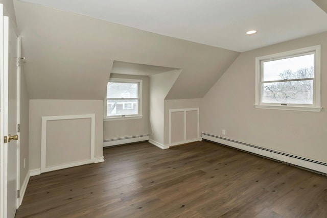 additional living space featuring a baseboard heating unit, lofted ceiling, dark wood finished floors, and recessed lighting