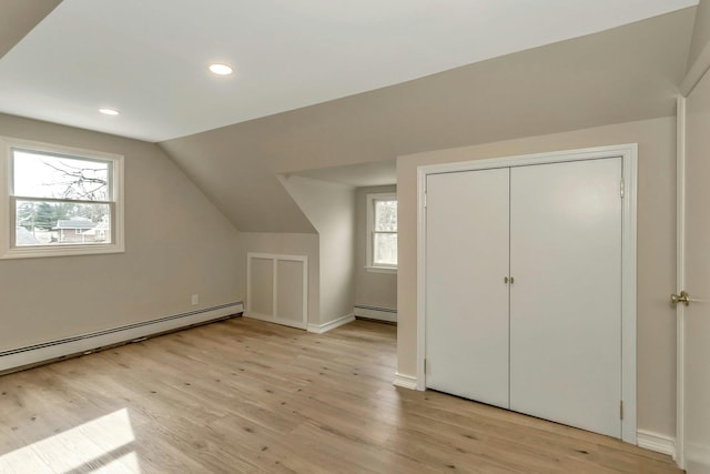 bonus room with lofted ceiling, light wood-style floors, baseboard heating, and recessed lighting