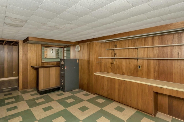 bar featuring dark floors and wood walls