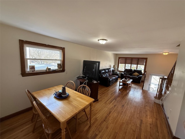 dining space with hardwood / wood-style floors