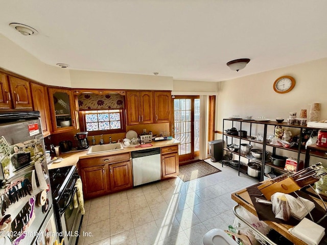 kitchen featuring sink, light tile patterned floors, and appliances with stainless steel finishes