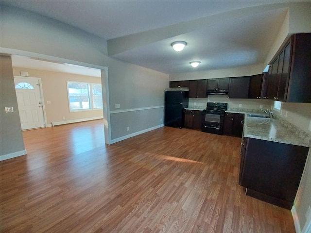 kitchen featuring sink, a baseboard heating unit, dark brown cabinets, black appliances, and light hardwood / wood-style floors