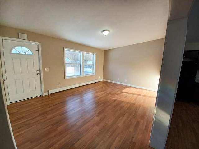 foyer entrance with baseboard heating and dark hardwood / wood-style floors