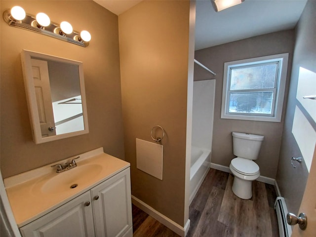 full bathroom with vanity, wood-type flooring, a baseboard radiator, shower / bathtub combination, and toilet