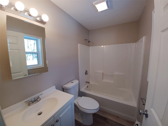 full bathroom featuring shower / tub combination, hardwood / wood-style floors, vanity, and toilet