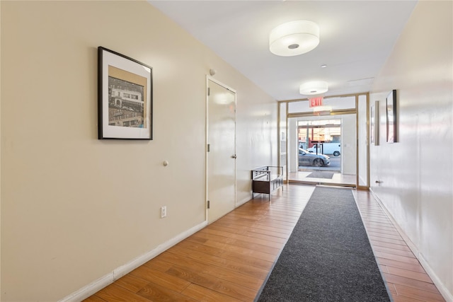 hall with hardwood / wood-style flooring