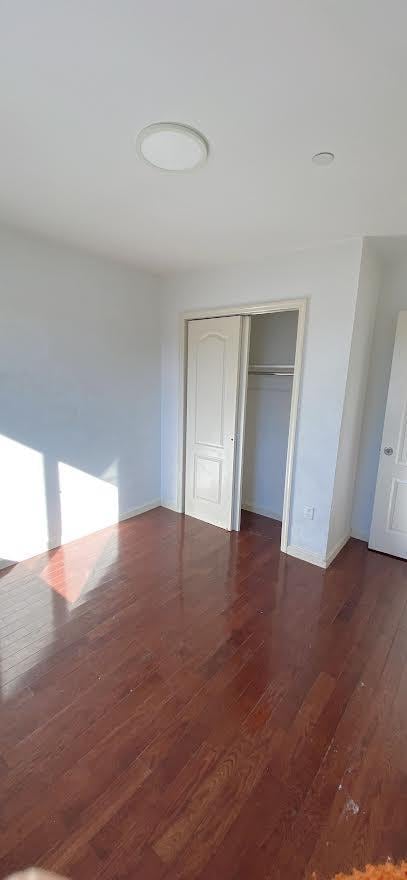 unfurnished bedroom featuring a closet and wood finished floors