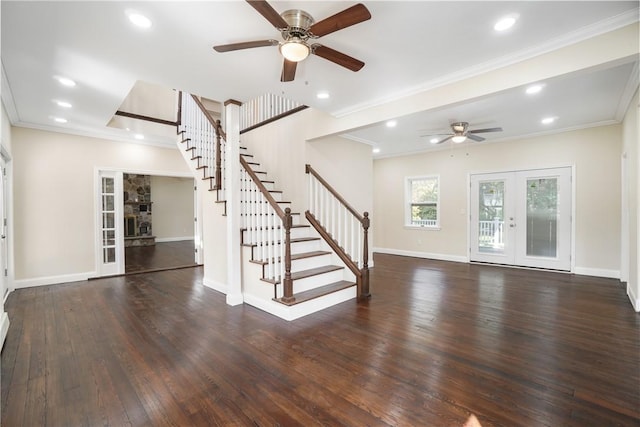 unfurnished living room with crown molding, ceiling fan, dark hardwood / wood-style flooring, and french doors