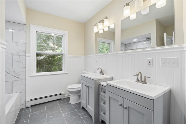 bathroom featuring baseboard heating, vanity, and toilet