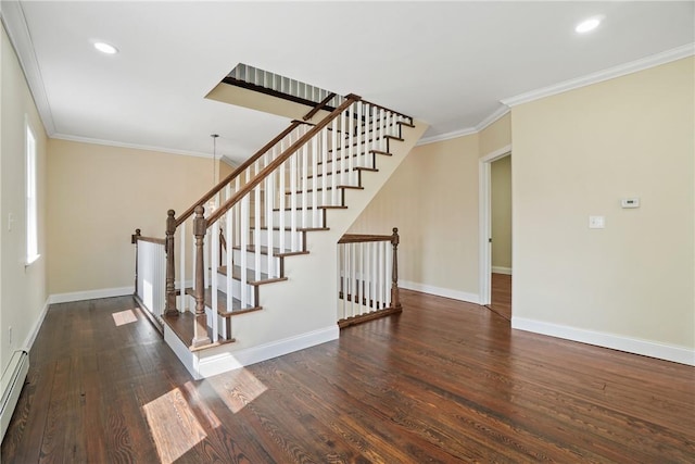 staircase featuring crown molding, hardwood / wood-style flooring, and baseboard heating