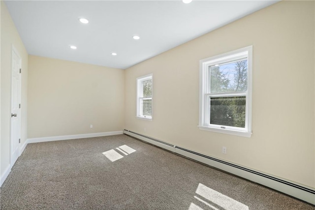 unfurnished room featuring a baseboard radiator and carpet floors