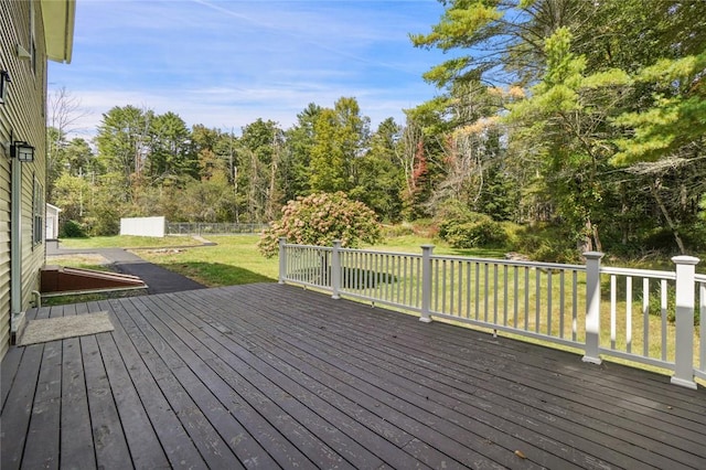 wooden terrace featuring a lawn