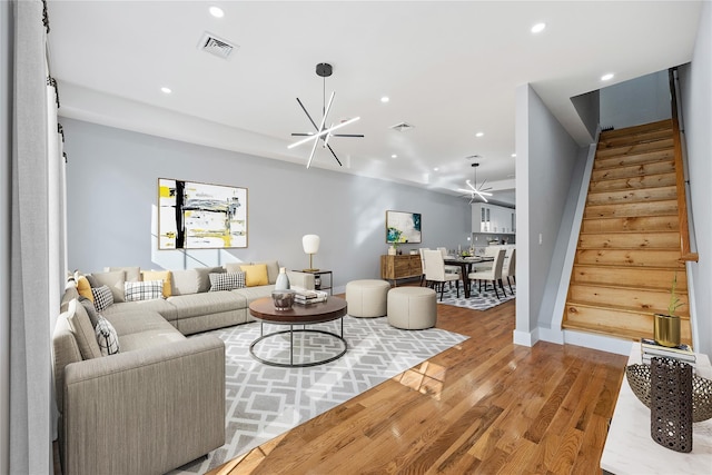 living room featuring an inviting chandelier and light hardwood / wood-style flooring