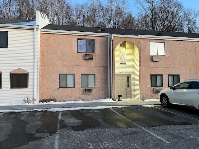 view of property featuring uncovered parking