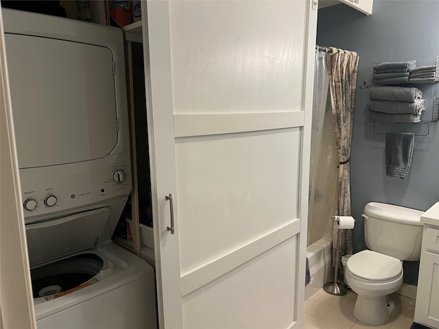 interior space with laundry area, stacked washing maching and dryer, and tile patterned flooring