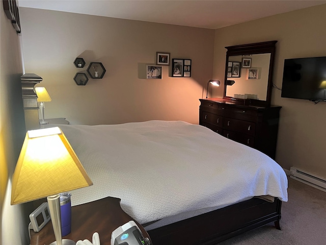 bedroom with a baseboard heating unit and carpet floors