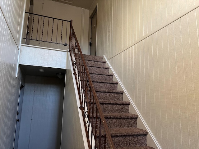 staircase with a towering ceiling