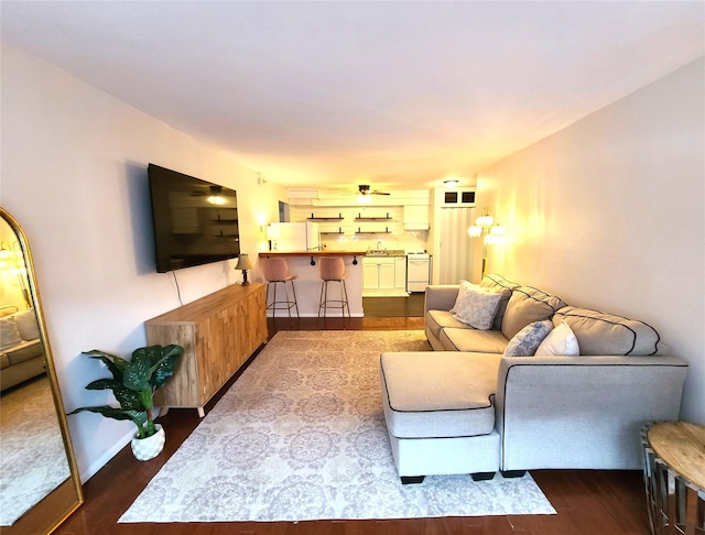 living room with wood-type flooring and ceiling fan