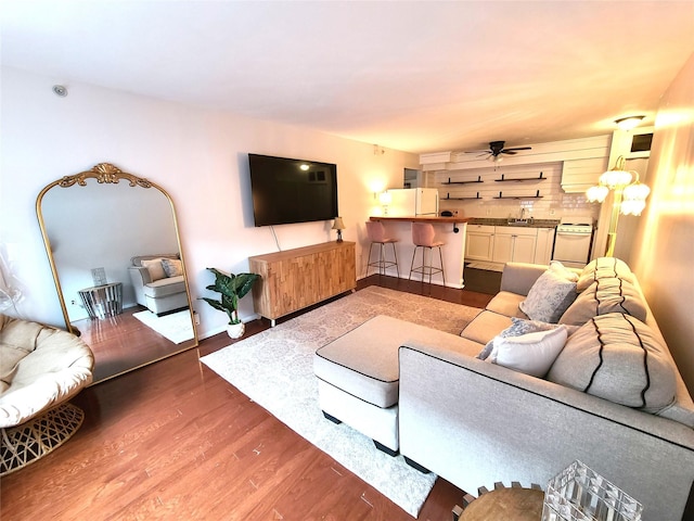 living room with wood-type flooring and ceiling fan