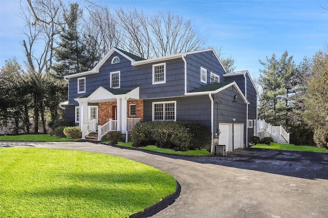 front facade featuring a garage and a front yard