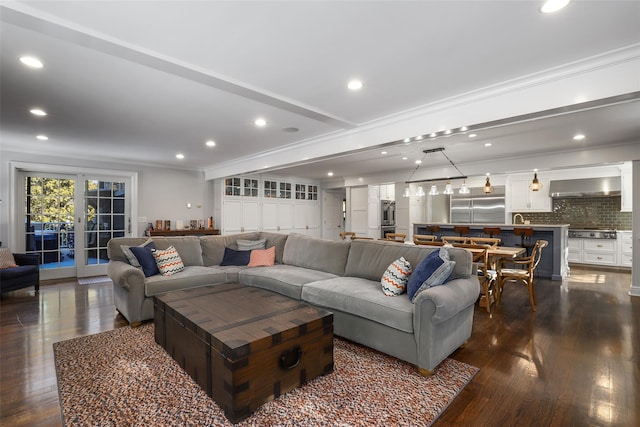 living room with crown molding, dark hardwood / wood-style floors, and french doors