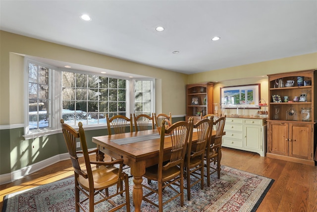 dining space with hardwood / wood-style flooring