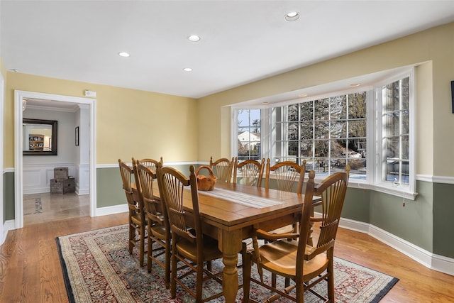 dining space with light hardwood / wood-style flooring