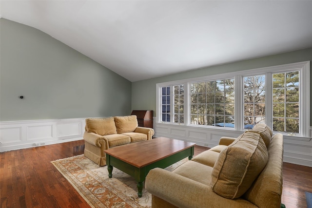 living room with wood-type flooring and vaulted ceiling