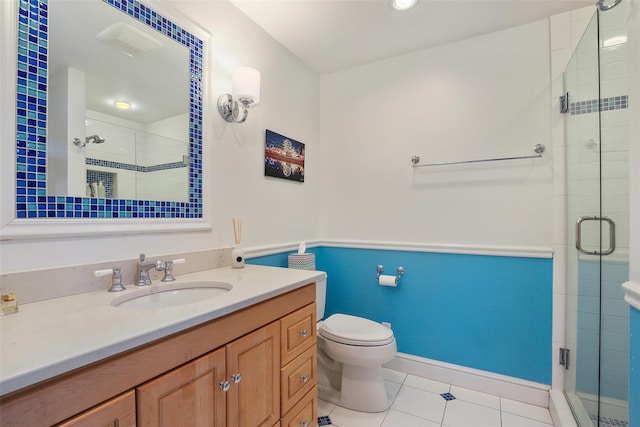 bathroom featuring vanity, toilet, an enclosed shower, and tile patterned flooring