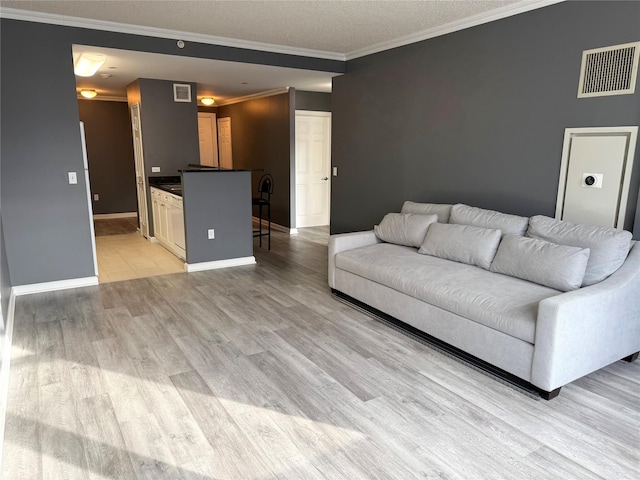 unfurnished living room with crown molding and light wood-type flooring