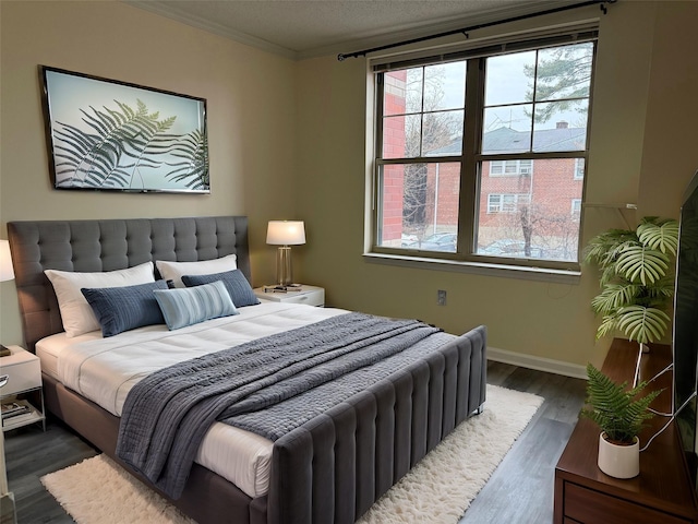 bedroom featuring dark hardwood / wood-style flooring and crown molding