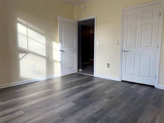 unfurnished bedroom featuring dark wood-type flooring