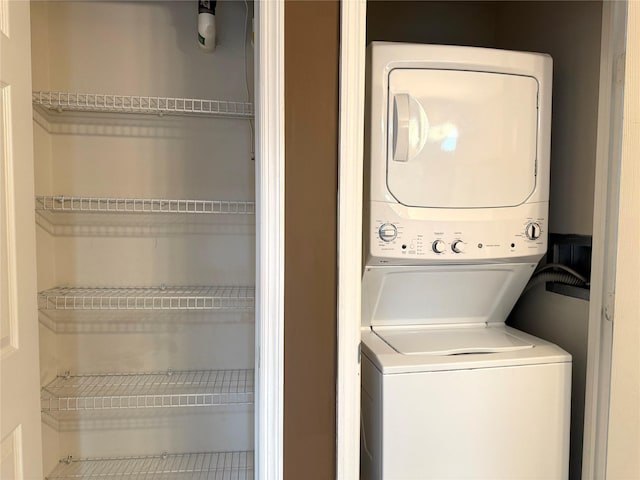 laundry room featuring stacked washer / drying machine