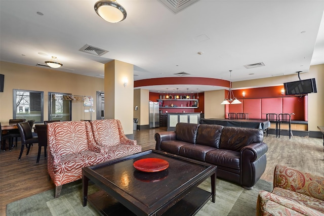 living room featuring hardwood / wood-style flooring and bar