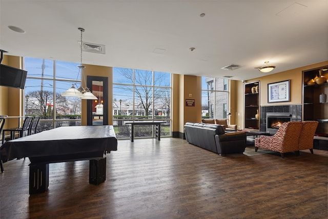 recreation room featuring dark hardwood / wood-style floors, a wealth of natural light, pool table, and floor to ceiling windows